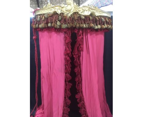 Bed canopy (width 65cm) with attached long red voile type curtains adorned with tassels and with tiebacks, together with a cr