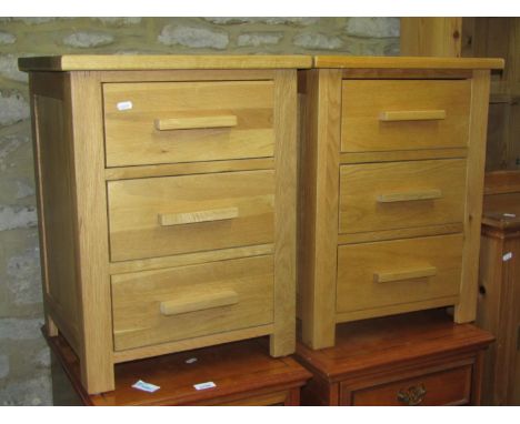 A pair of contemporary light oak three drawer bedside chests, 47 cm wide x 40 cm deep x 60 cm high 