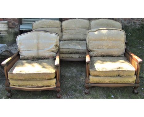 A good quality mahogany bergere suite comprising a three seat sofa and two armchairs, the frames with double cane panels, car