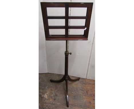 A Regency style mahogany sheet music stand with adjustable frame, the fluted column set on a swept tripod base 