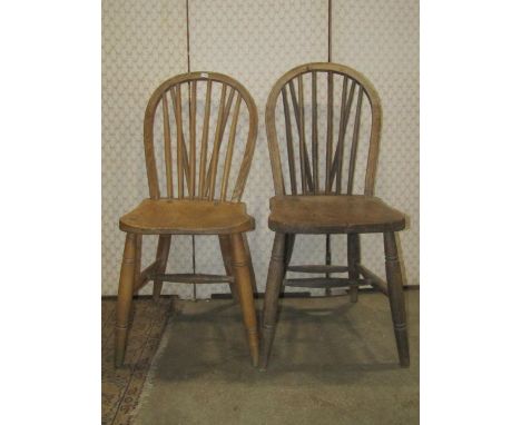 A Harlequin set of six stripped elm and beechwood hoop and stick back kitchen chairs raised on ring turned and splayed suppor
