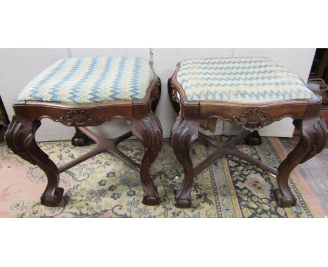 A good pair of 19th century rosewood centre stools, probably Portuguese, with serpentine outline, raised on shaped supports w
