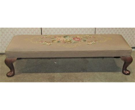 A hearth/long footstool with rectangular floral tapestry upholstered top raised on walnut cabriole supports, 100 cm long x 35