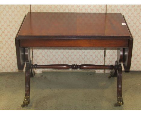 A small good quality reproduction Regency style drop leaf sofa type table, with reeded outline raised on swept supports with 