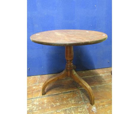 A Georgian oak occasional table the circular top 55cm in diameter, raised on a turned tripod (reduced in height), 53 cm high,