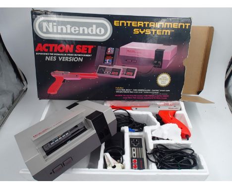 Boxed Nintendo NEW action set entertainment system in VG box, some damage to Styrofoam. Nes, PSU, Light Gun and 2 control pad