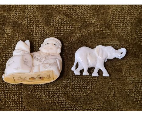Carved bone Netsuke and small elephant.