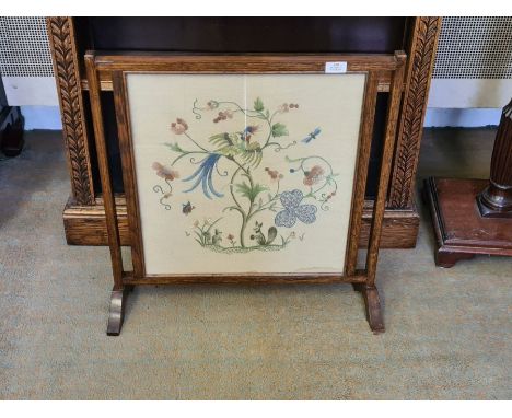 An oak needlework fire screen.