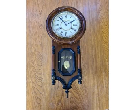 Modern mahogany Commodoor regulator wall clock in working condition.
