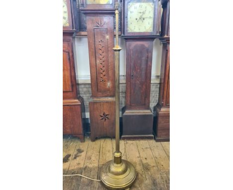 A heavy brass telescopic standard lamp with hammered base and reeeded column, standing between 142cm and 190cm.