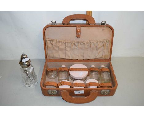 A vintage travelling vanity set together with a cut glass sugar caster