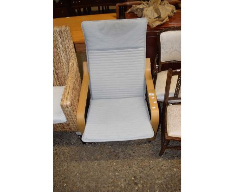 A modern light wood framed armchair