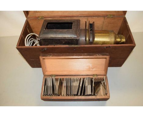 Vintage projector together with a case of glass slides