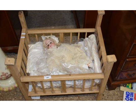 A Simon &amp; Halbig porcelain headed doll together with assorted clothes and a cot