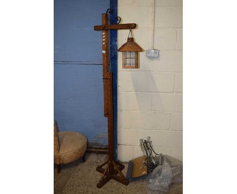 An adjustable hardwood framed lantern style standard lamp