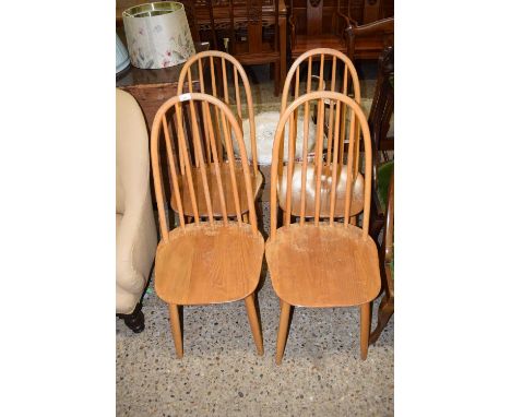 A set of four mid Century stick back dining chairs likely Ercol