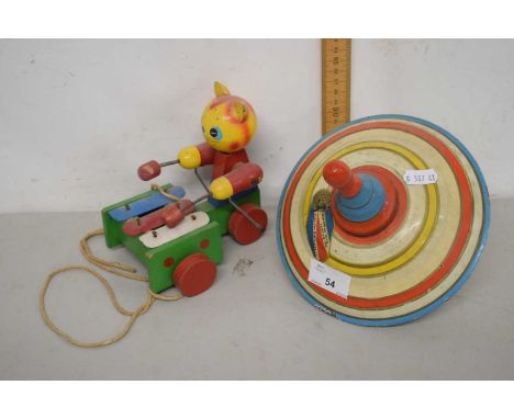 A vintage spinning top and a push along cat toy