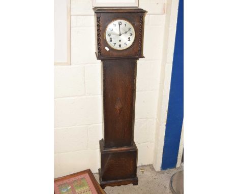 An early 20th Century grandmother clock in oak case with barley twist supports