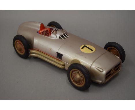 A vintage tinplate racing car. 32 cm long.