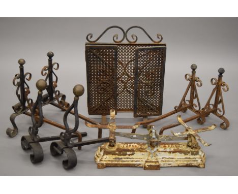 Three pairs of wrought iron andirons, a set of scales and a fireguard.