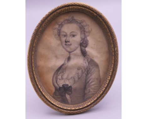 A 19th century pencil portrait miniature of a young lady, framed and glazed. 6.5 cm high overall.