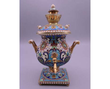 A silver and enamel model of a samovar bearing Russian marks. 10.5 cm high.