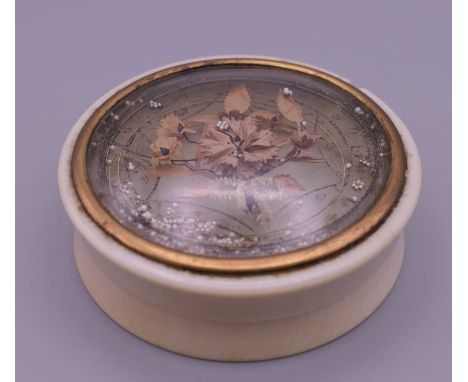 A 19th century ivory snuff box. 6.5 cm diameter.