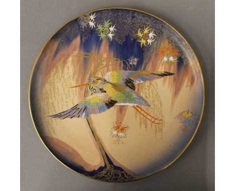 A Carltonware charger decorated with a bird. 32 cm diameter.