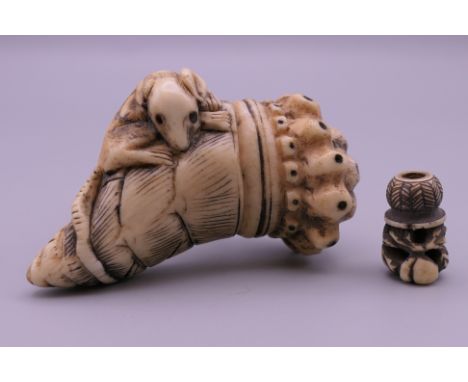 A 19th century Japanese ivory netsuke formed as a rat on a cornucopia and a toggle.