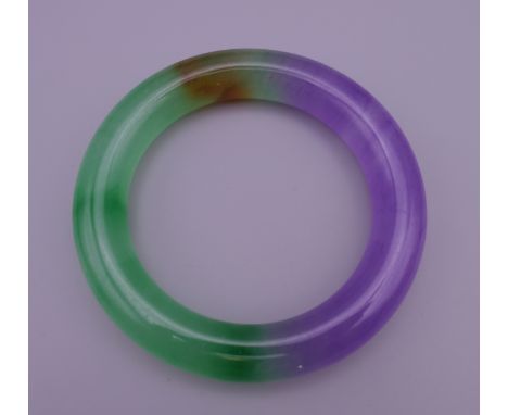 A two tone jade bangle.  6 cm internal diameter.