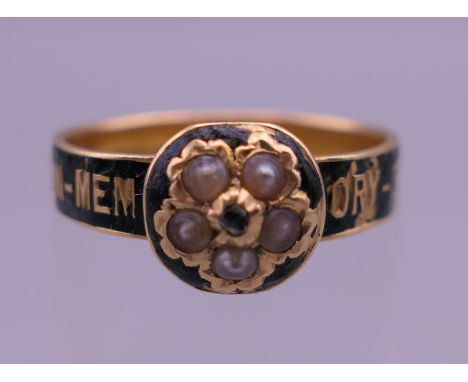 A Victorian 18 ct gold seed pearl and enamel mourning ring. Ring size N/O. 2.9 grammes total weight.