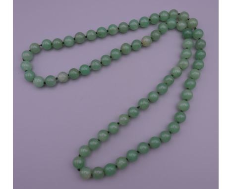 A string of jade beads.  85 cm long.