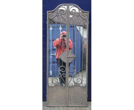 A wrought iron gate formed mirror. 150 cm high.