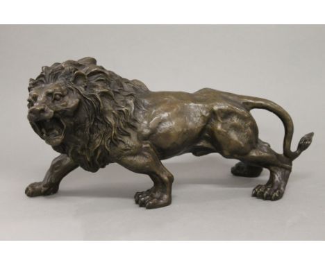A bronze model of a lion. 31 cm long.