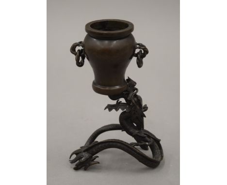 A Chinese bronze vase formed as a dragon. 17.5 cm high.