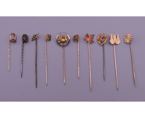 Ten vintage gold stick pins.  Largest 6.5 cm long.