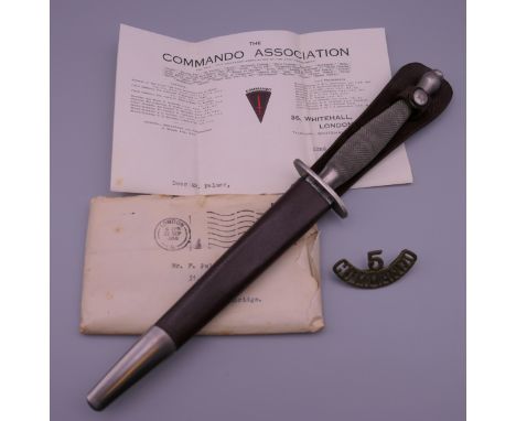 A Fairburn-Sykes Commando fighting knife with scabbard, the blade etched to one side 'Wilkinson Sword Co Ltd London', the oth