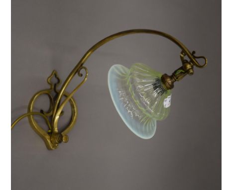 An Art Nouveau brass lamp with uranium glass shade. 37 cm high.