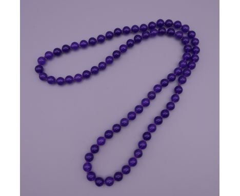 A lavender jade bead necklace.  70 cm long.