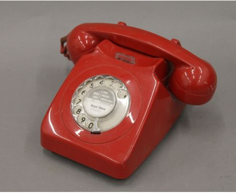 A vintage red telephone.