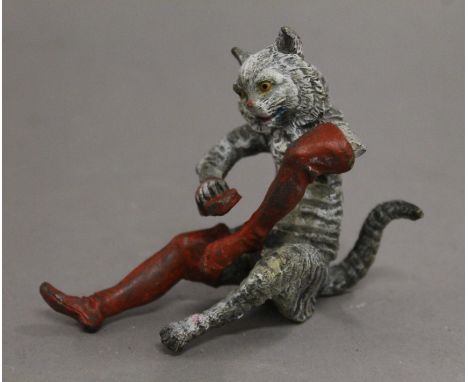 A cold painted bronze model of a cat in boots. 7.5 cm high.