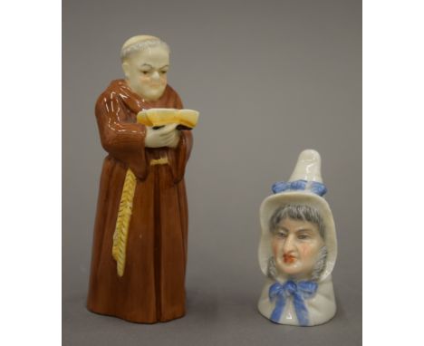 Two Royal Worcester candle snuffers, one formed as a monk, the other an old lady. The former 12 cm high.