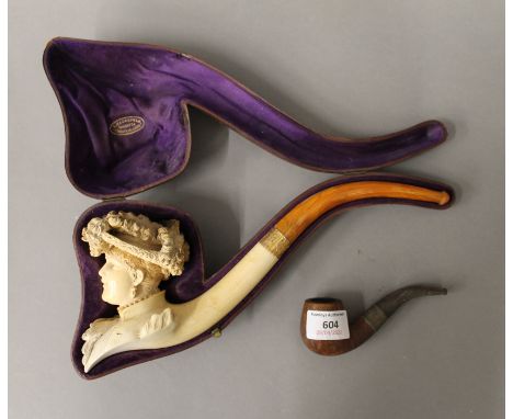 A Victorian cased meerschaum pipe formed as a lady and another pipe.  30 cm long, 10.5 cm high. 