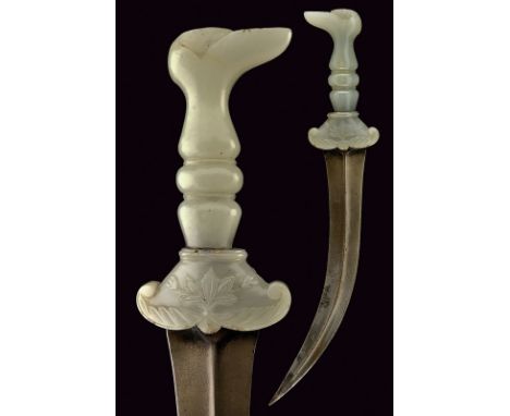 A jade hilted kandshar dating: circa 1800provenance: India MoghulCurved, double-edged damask blade with central raiser; jade 