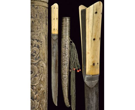 A bichaq knife with silver scabbard dating: 19th Centuryprovenance: GreeceStraight, single-edged blade with hollow faces, the