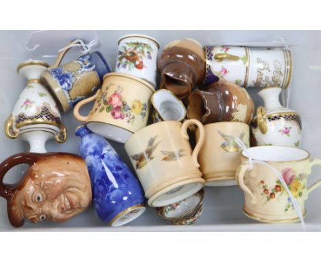 A collection of miniature ceramics, including four Royal Worcester blush ivory mugs and a tyg, variously painted with flowers