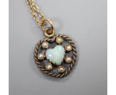 An Edwardian heart shaped white opal and seed pearl set heart shaped pendant on a fine link chain, pendant 22mm.