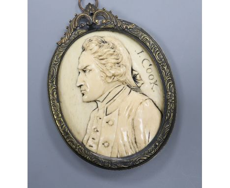 A 19th century carved ivory oval portrait plaque, signed J. Cook