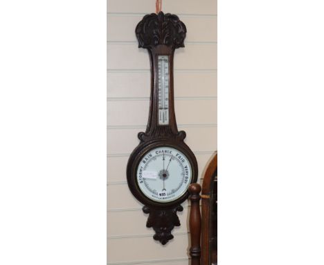 An Edwardian oak wheel barometer and thermometer H.82cm