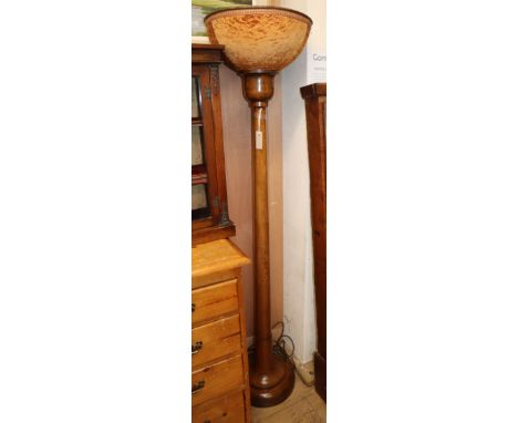 A 1930's oak uplighter lamp standard, with fabric covered shade